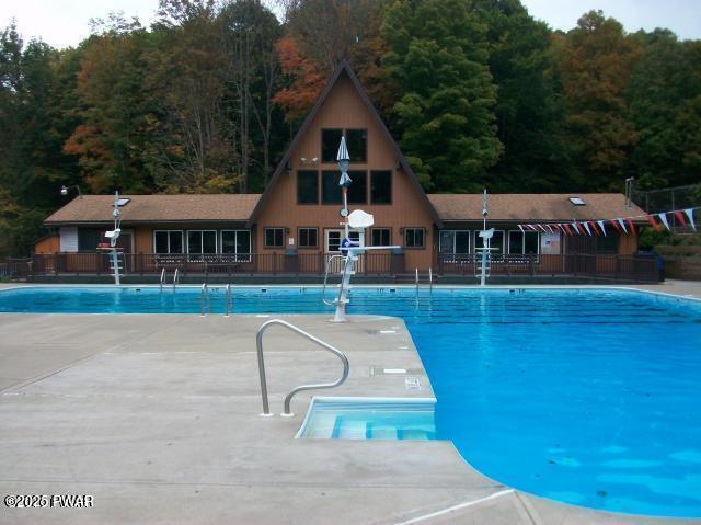 1011 Salem Pl, Lake Ariel, PA 18436 - community pool featuring a wooded view and a patio