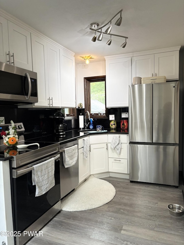 1267 Brookfield Rd, Lake Ariel, PA 18436 - kitchen with stainless steel appliances, dark countertops, white cabinetry, and wood finished floors