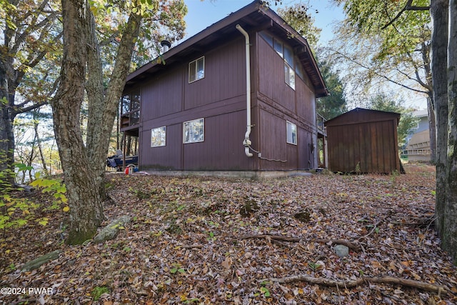 view of side of home with a storage unit