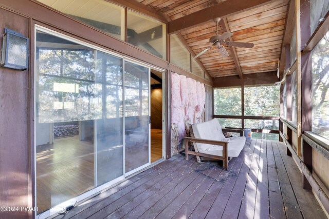 unfurnished sunroom featuring lofted ceiling with beams, ceiling fan, and wooden ceiling