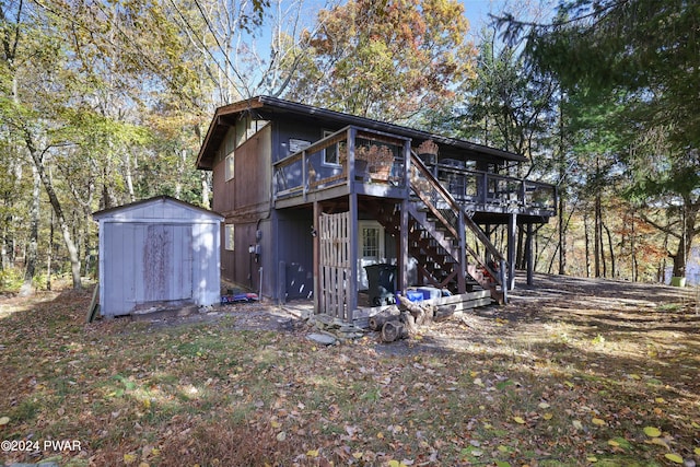 rear view of house featuring a shed and a deck