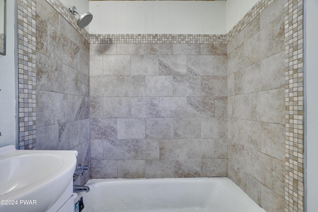 bathroom featuring sink and tiled shower / bath