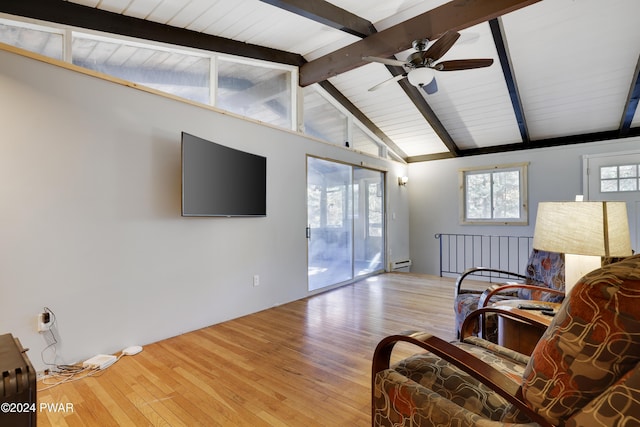 living room with baseboard heating, vaulted ceiling with beams, ceiling fan, and light wood-type flooring