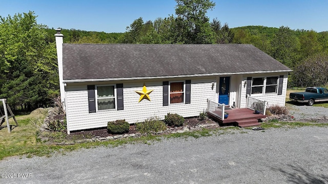 108 Boyds Mills Rd, Beach Lake, PA 18405 - view of front of home with a chimney, a forest view, and roof with shingles