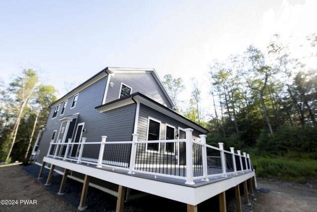 back of house with a wooden deck