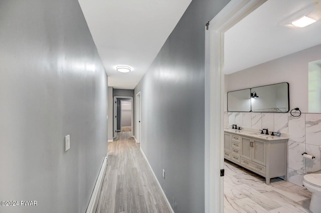 1412 Woodview Ter # 56, Lake Ariel, PA 18436 - hallway featuring a sink, tile walls, and light marble finish floors