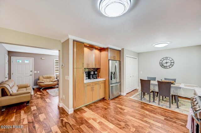 1412 Woodview Ter # 56, Lake Ariel, PA 18436 - kitchen featuring stainless steel refrigerator with ice dispenser, light wood-type flooring, light countertops, open floor plan, and baseboards