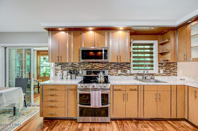1412 Woodview Ter # 56, Lake Ariel, PA 18436 - kitchen with appliances with stainless steel finishes, a sink, decorative backsplash, open shelves, and light wood finished floors