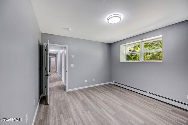 1412 Woodview Ter # 56, Lake Ariel, PA 18436 - unfurnished room with a baseboard radiator, light wood-type flooring, and baseboards
