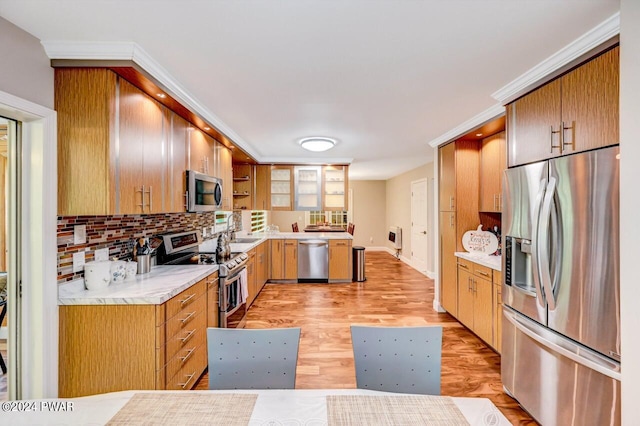 1412 Woodview Ter # 56, Lake Ariel, PA 18436 - kitchen featuring stainless steel appliances, a sink, decorative backsplash, light countertops, and light wood-type flooring