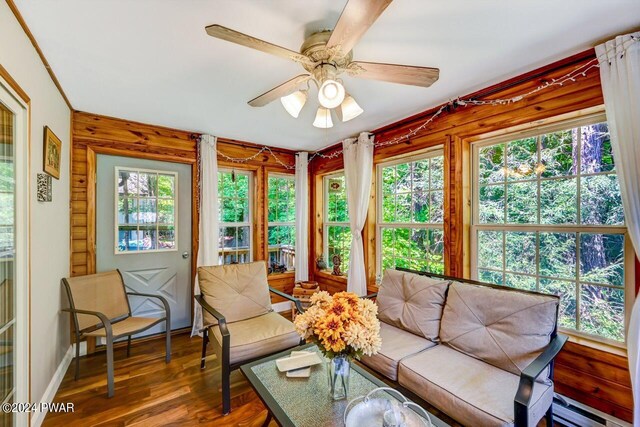 1412 Woodview Ter # 56, Lake Ariel, PA 18436 - sunroom featuring wood finished floors, baseboard heating, and baseboards