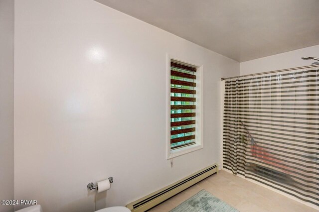 1412 Woodview Ter # 56, Lake Ariel, PA 18436 - full bath with a baseboard radiator, toilet, a shower with shower curtain, and tile patterned floors