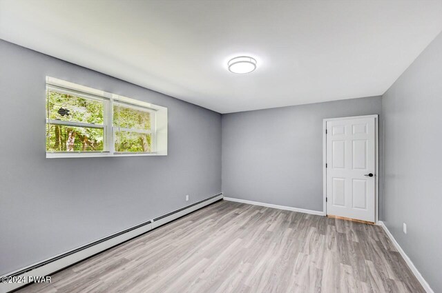 1412 Woodview Ter # 56, Lake Ariel, PA 18436 - unfurnished room featuring baseboard heating, wood finished floors, and baseboards