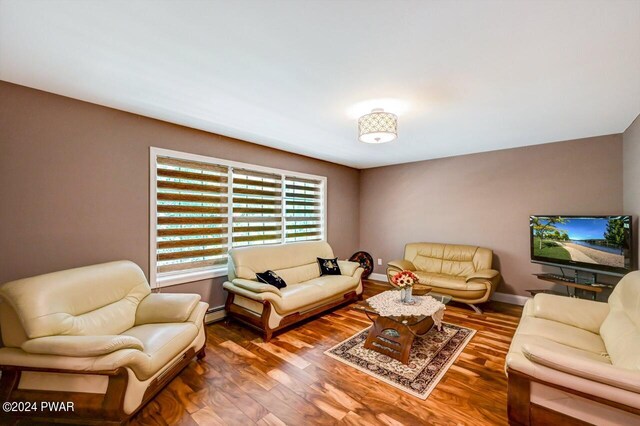 1412 Woodview Ter # 56, Lake Ariel, PA 18436 - living room with wood finished floors, baseboards, and a baseboard radiator
