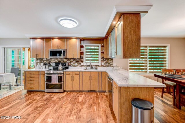 1412 Woodview Ter # 56, Lake Ariel, PA 18436 - kitchen featuring appliances with stainless steel finishes, open shelves, light countertops, backsplash, and light wood-type flooring