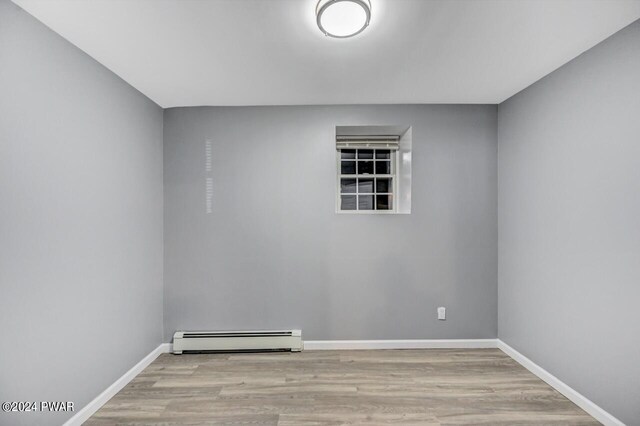1412 Woodview Ter # 56, Lake Ariel, PA 18436 - spare room featuring a baseboard radiator, wood finished floors, and baseboards