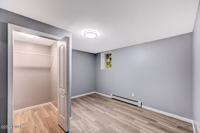 1412 Woodview Ter # 56, Lake Ariel, PA 18436 - unfurnished bedroom with baseboard heating, wood finished floors, and baseboards