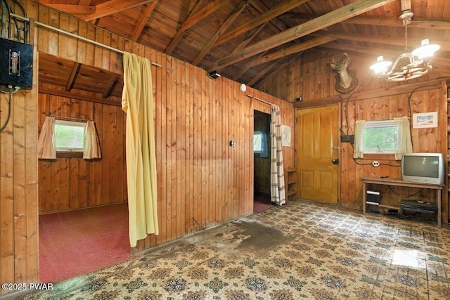 193 Old Rte 402, Dingmans Ferry, PA 18328 - unfurnished living room featuring a chandelier, wood walls, a wood ceiling with exposed beams, and high vaulted ceiling
