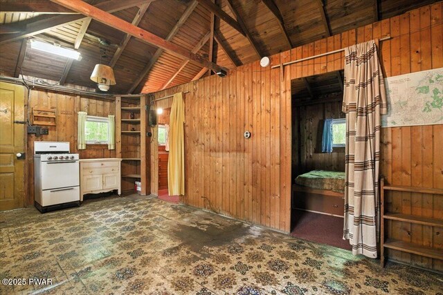 193 Old Rte 402, Dingmans Ferry, PA 18328 - kitchen featuring white gas range, wooden walls, and vaulted ceiling