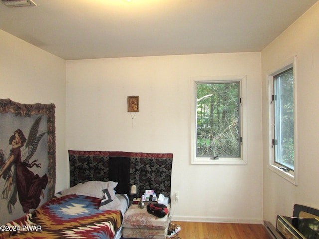 bedroom featuring light wood-type flooring and multiple windows