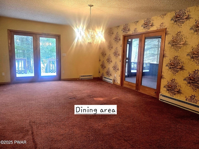 carpeted spare room with baseboard heating, a notable chandelier, and a textured ceiling