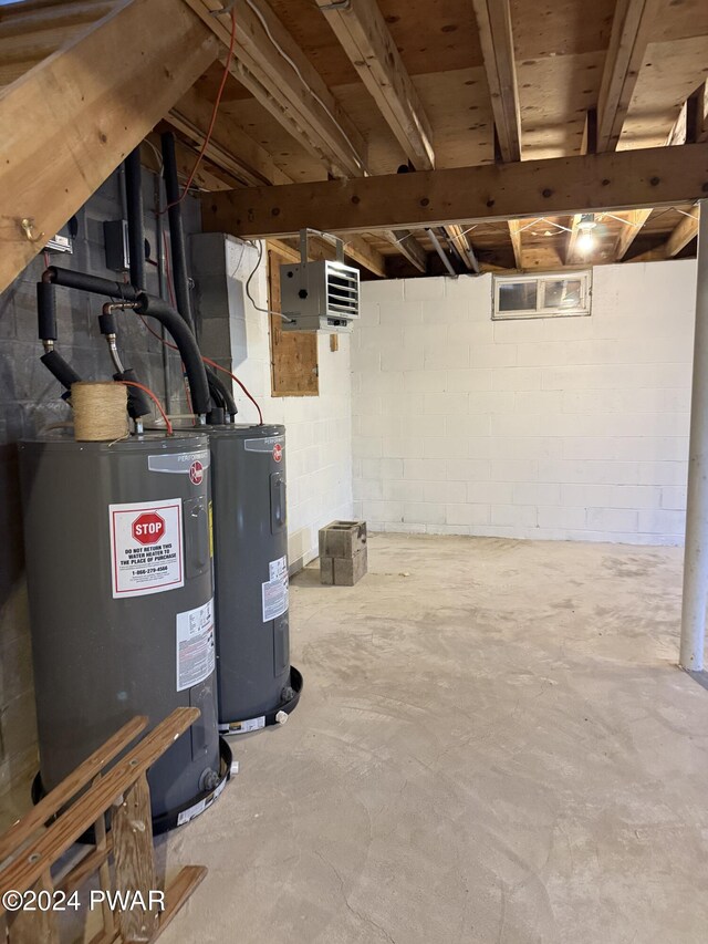 basement with electric water heater and gas water heater