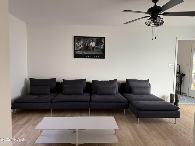 living room featuring ceiling fan and light hardwood / wood-style floors