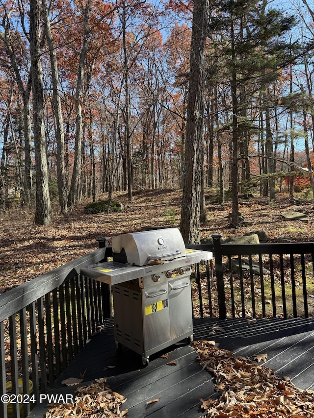 wooden deck featuring area for grilling