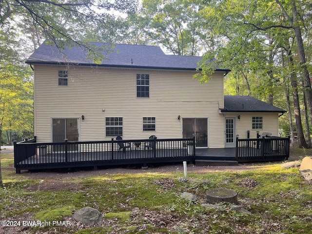 back of property featuring a deck