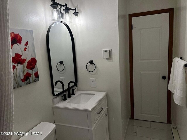 bathroom featuring toilet, vanity, and tile patterned floors