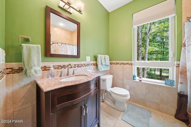 49 White Pine Cir, Lake Ariel, PA 18436 - bathroom with tile patterned floors, tile walls, plenty of natural light, vanity, and a wainscoted wall