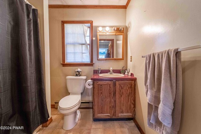 bathroom with vanity, toilet, baseboard heating, and crown molding