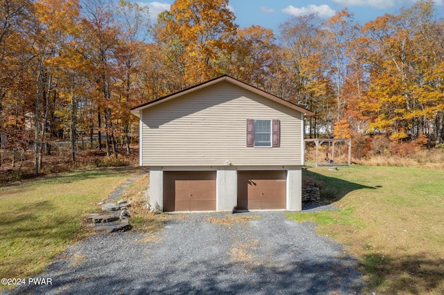 view of side of property with a yard and a garage