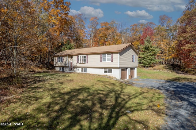 split foyer home with a garage and a front lawn