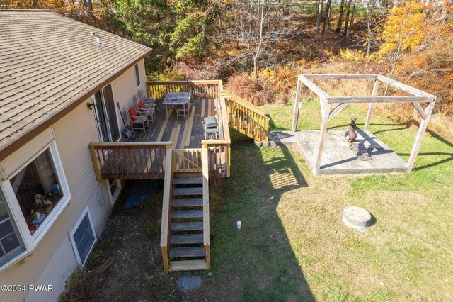 exterior space with a wooden deck, a patio area, and a yard