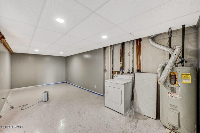 finished basement featuring a drop ceiling, washer / clothes dryer, water heater, recessed lighting, and concrete block wall