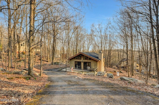 139 Ridgeview Dr, Lake Ariel, PA 18436 - view of front of home featuring driveway, a chimney, and covered porch
