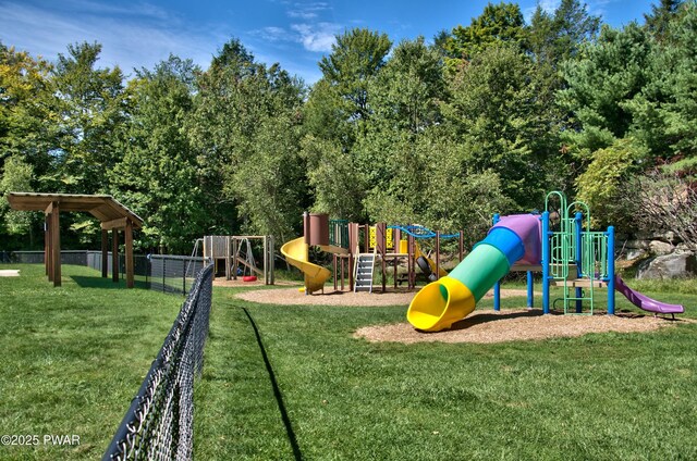 community play area with fence and a lawn