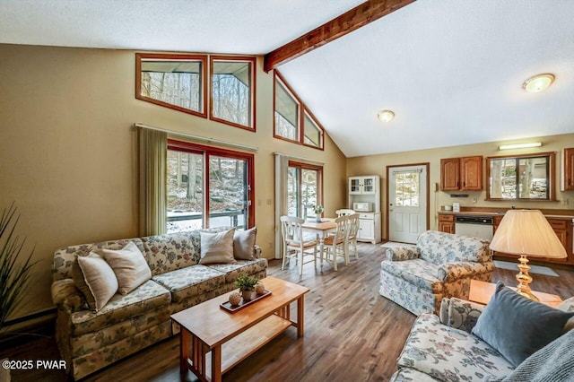 living room with beam ceiling, high vaulted ceiling, and wood finished floors