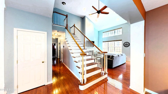 504 St Ives Ct, Bushkill, PA 18324 - staircase featuring hardwood / wood-style flooring, a high ceiling, ceiling fan, and baseboards