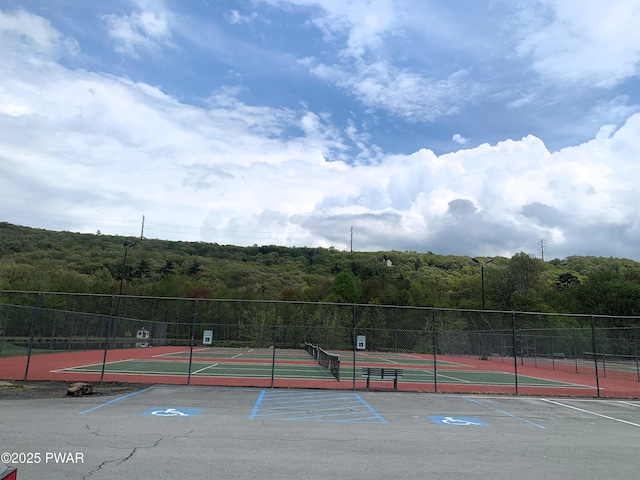 504 St Ives Ct, Bushkill, PA 18324 - view of tennis court with a wooded view and community basketball court