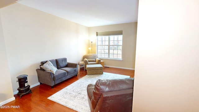 living room with baseboards and wood finished floors