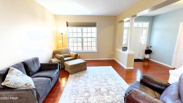 504 St Ives Ct, Bushkill, PA 18324 - living room with ornate columns, healthy amount of natural light, wood finished floors, and baseboards