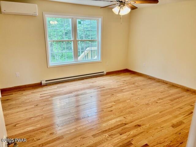 9 Wallenpaupack Dr, Lake Ariel, PA 18436 - unfurnished room with a wall mounted air conditioner, a baseboard radiator, a ceiling fan, and light wood-type flooring