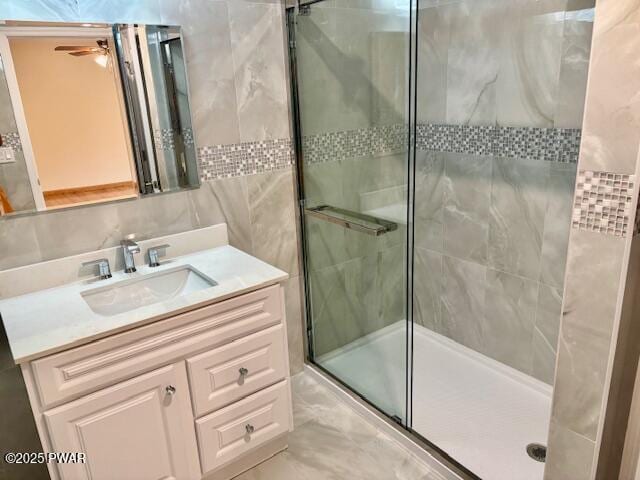9 Wallenpaupack Dr, Lake Ariel, PA 18436 - bathroom featuring a shower stall, vanity, tile walls, and a ceiling fan
