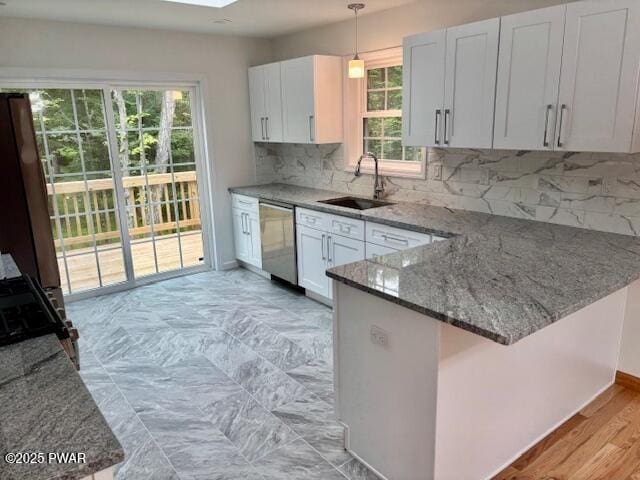 9 Wallenpaupack Dr, Lake Ariel, PA 18436 - kitchen with stainless steel dishwasher, stone countertops, range, a peninsula, and hanging light fixtures