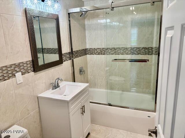 9 Wallenpaupack Dr, Lake Ariel, PA 18436 - bathroom with tile walls, vanity, and bath / shower combo with glass door