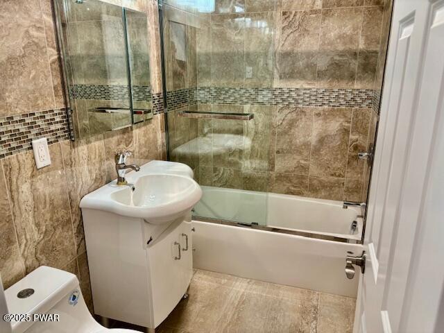 9 Wallenpaupack Dr, Lake Ariel, PA 18436 - bathroom with tile walls, vanity, and enclosed tub / shower combo
