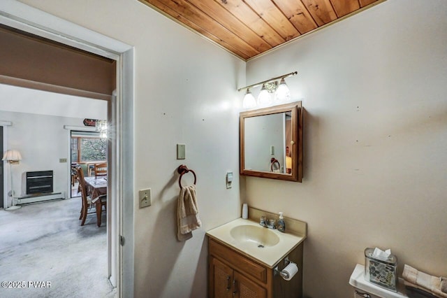 bathroom featuring vanity, wood ceiling, heating unit, and toilet