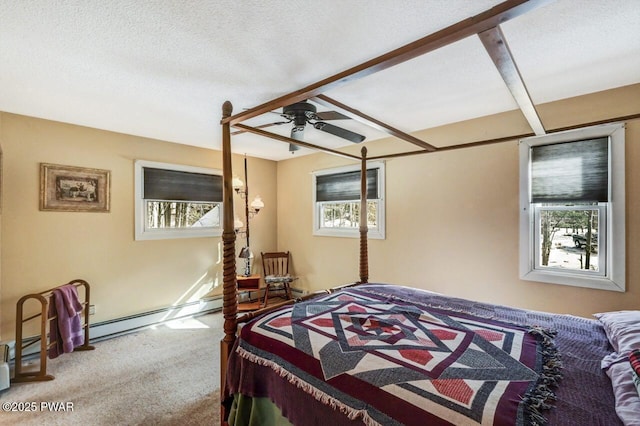 carpeted bedroom with multiple windows, a textured ceiling, and baseboard heating